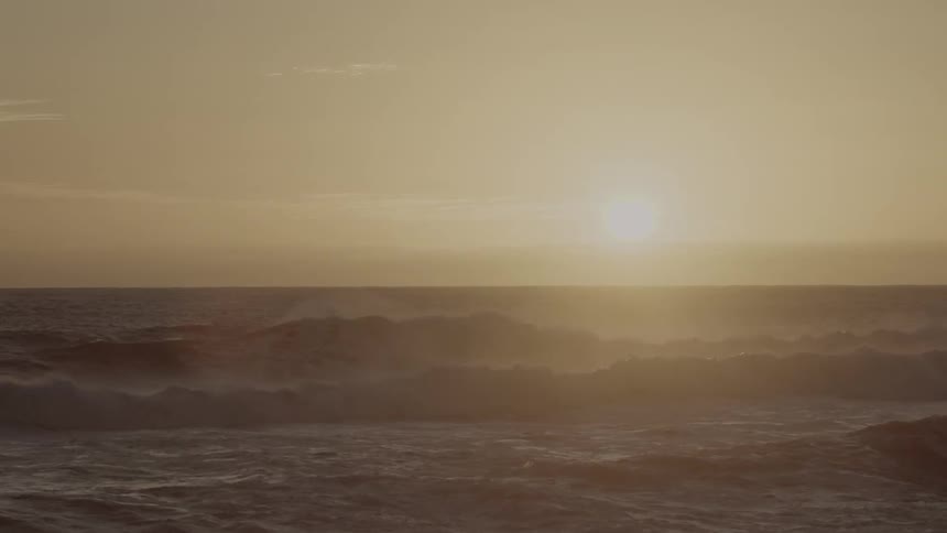 The sun is setting over this rough beach