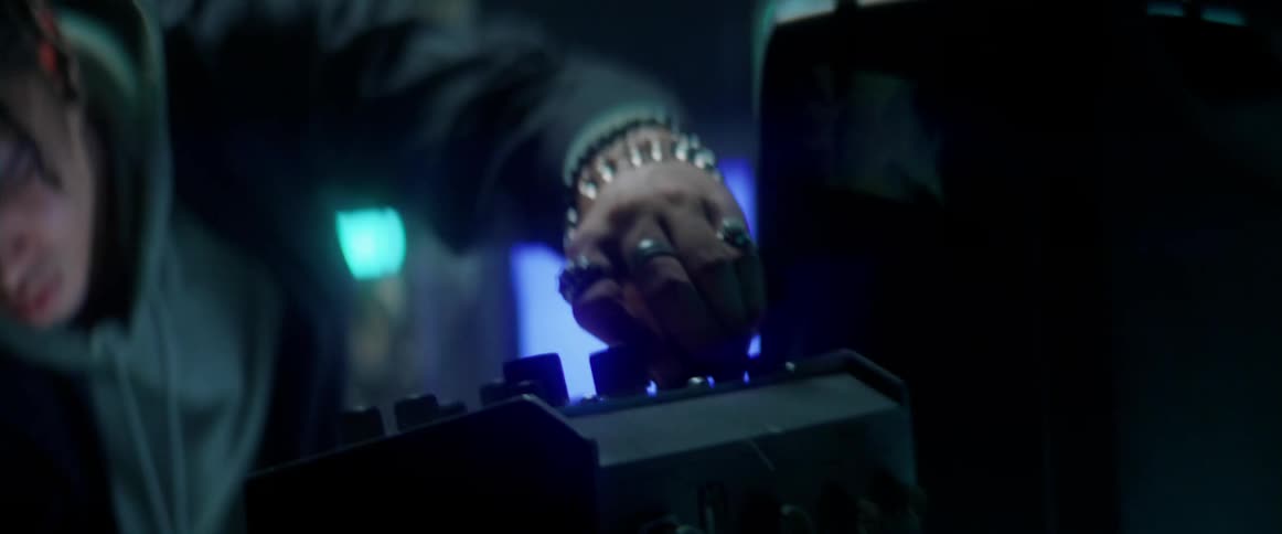 Young man using electronic equipment inside a dimly lit room