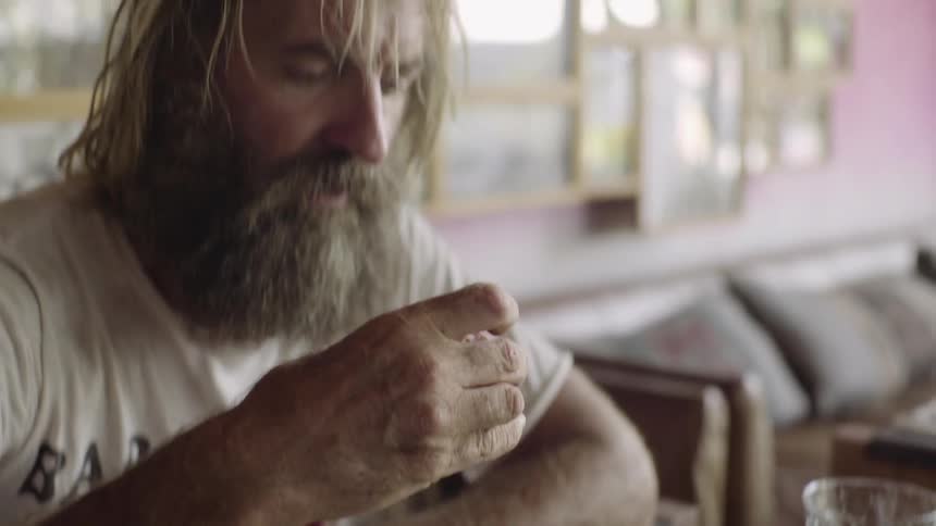 A bearded man eats after handed his change