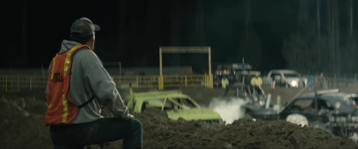A man is watching cars destruct each other