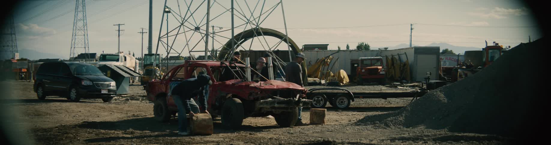 People are walking around a parking in a rural area