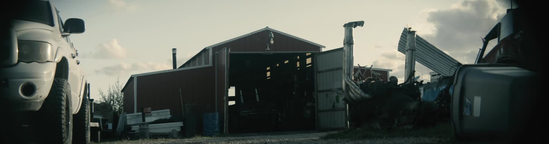 Truck sits parked near large free standing storage building