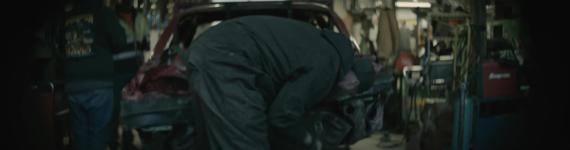 A mechanic jacks up the vehicle