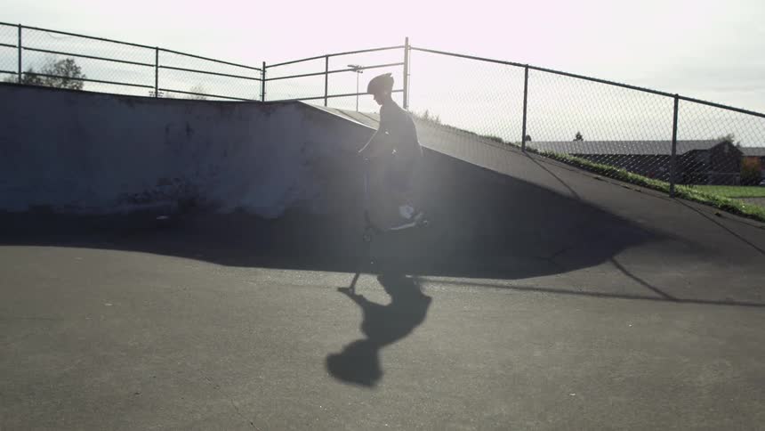 Kids are skating in a park on a cloudy day