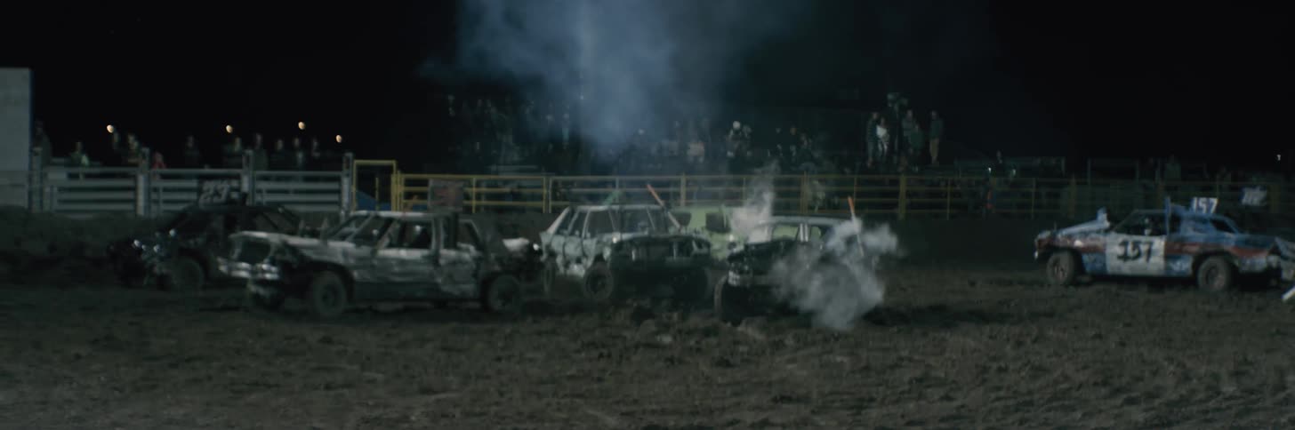 Car crashes into another during demo derby at night