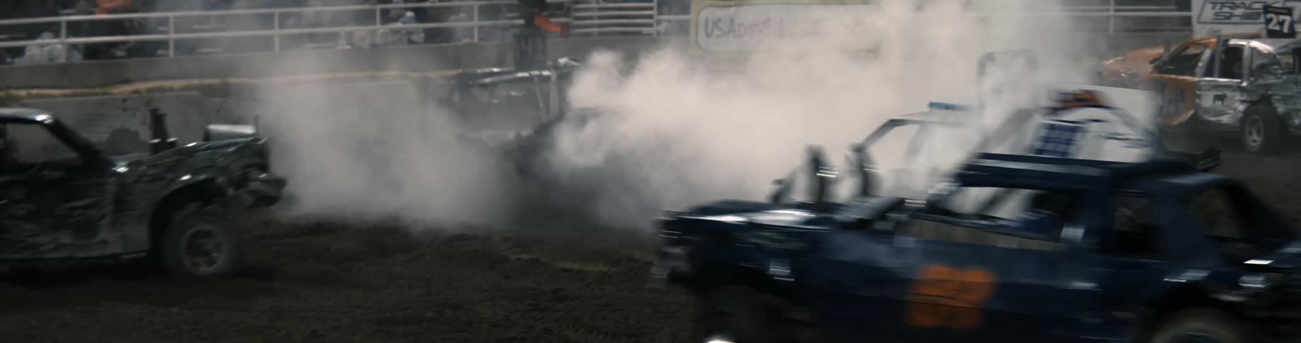 Competitors drive around arena and crash into each other at demolition derby