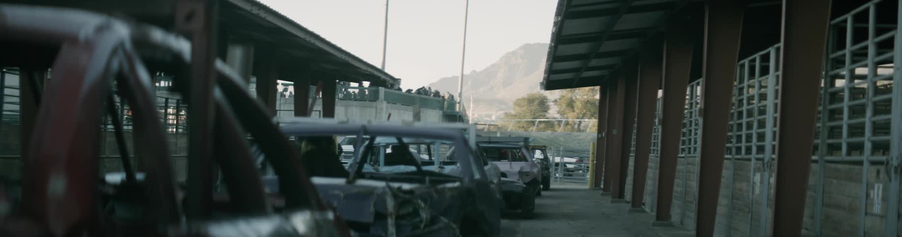 Cars are parked outside of a building at dusk