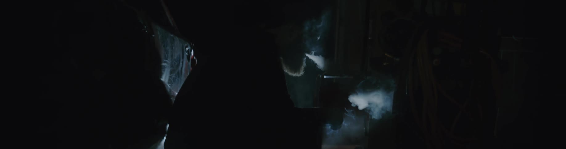A man is sitting inside a car during the night time
