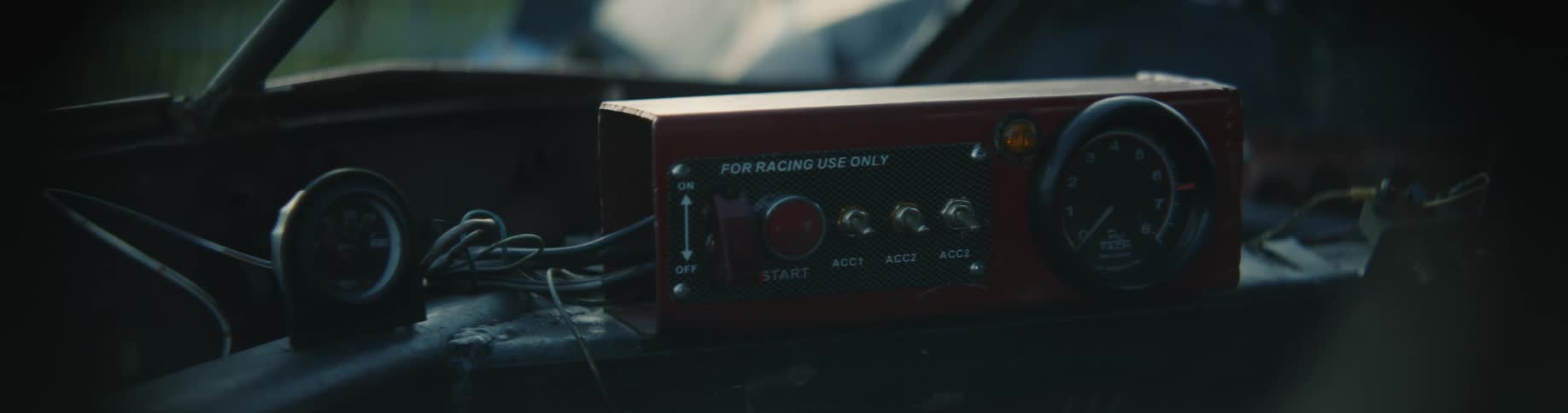 A portable radio sits on the dashboard of a vehicle
