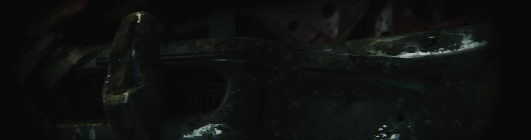 The wrecked car is in the garage