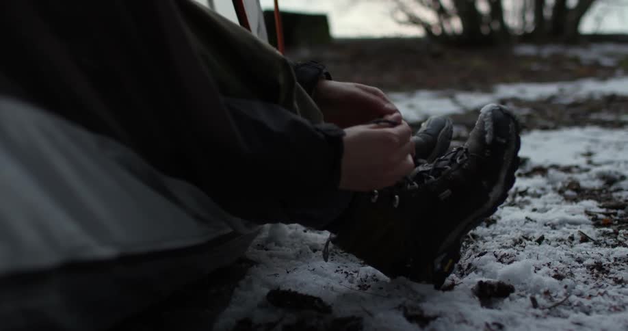 A person is tying their boots