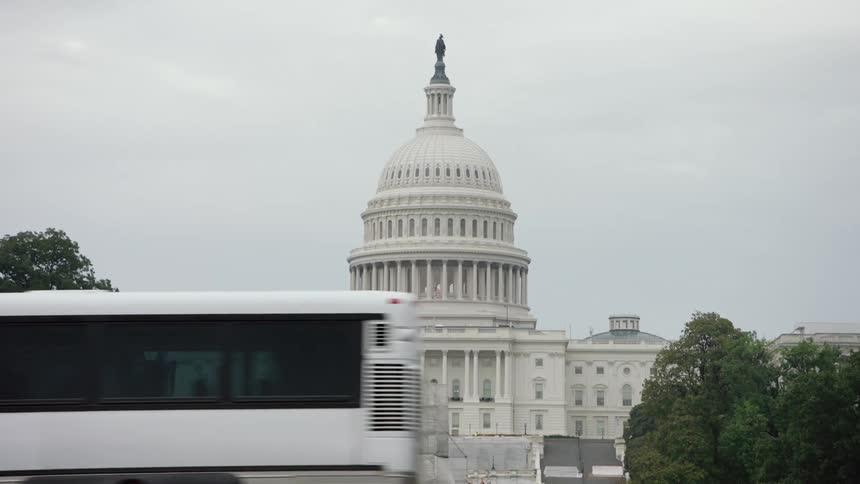 Vehicles drive past the capitol building