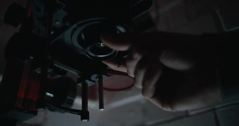 A person turns the lens on the camera