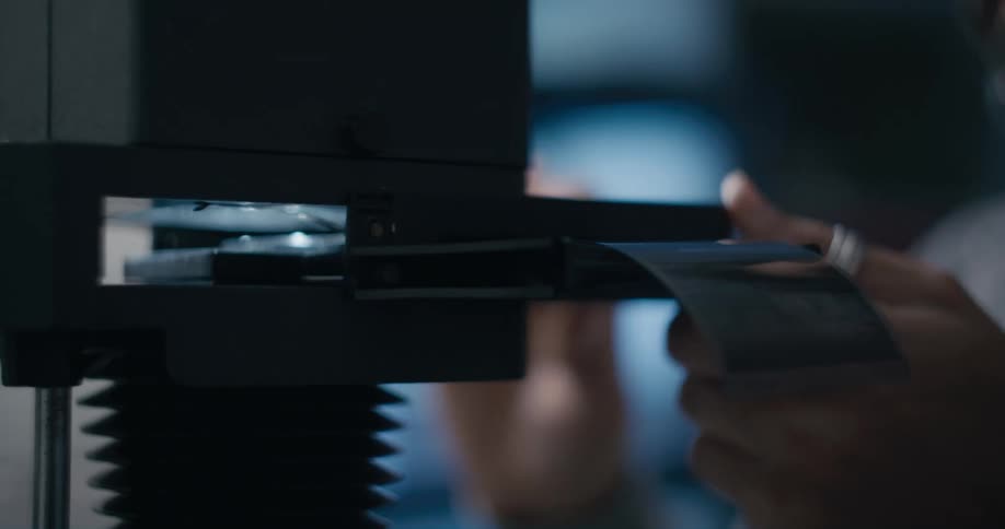 A man looks at then places a cartridge into a device