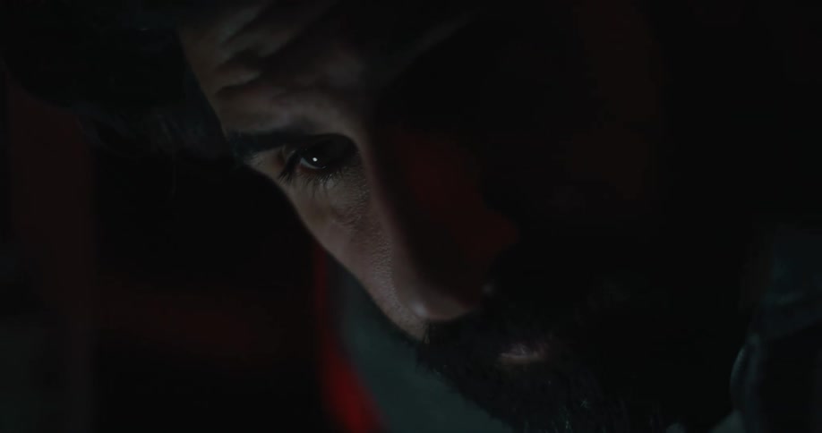 A man is leaning forward looking at something