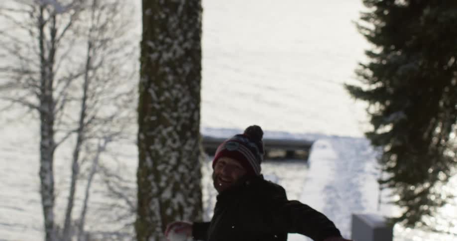 A man throws a snowball outside