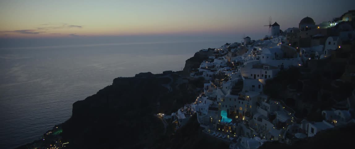 Heavy traffic passes through a picturesque neighborhood along the coast