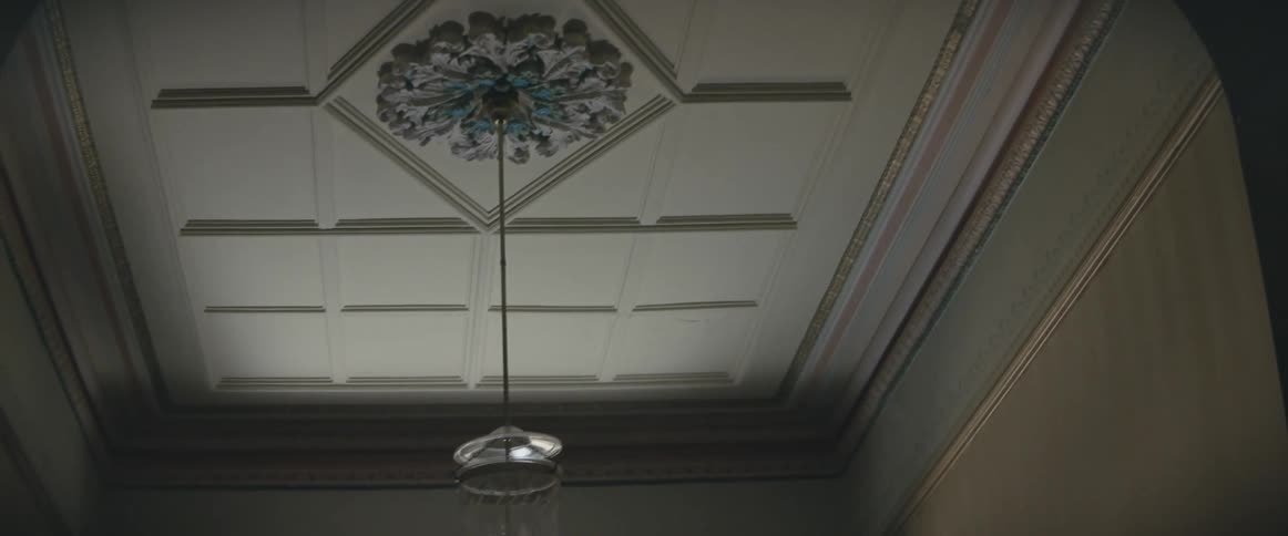 Sunlight washes over the ceiling in a hallway
