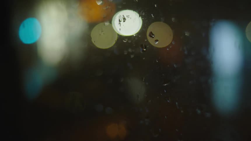 The window is covered with rain