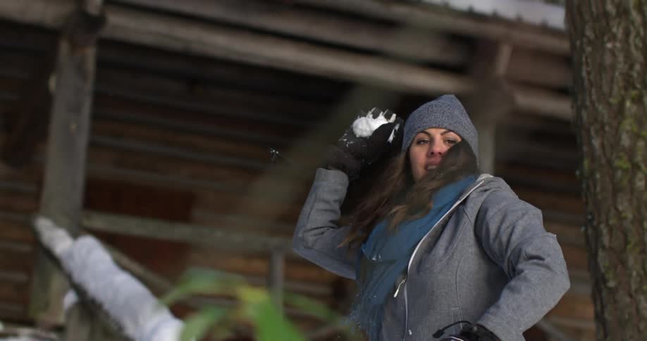 A woman throws a snowball