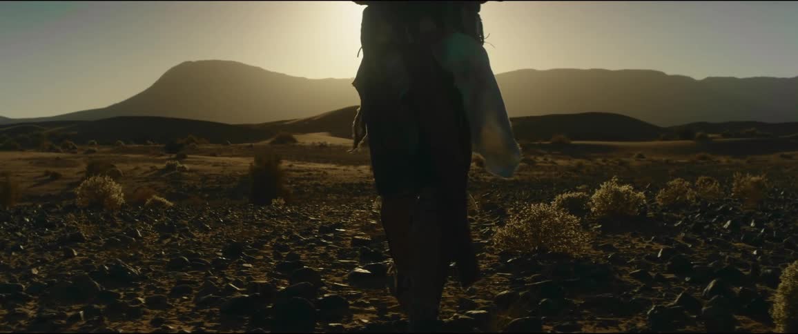 A man is hiking in the desert