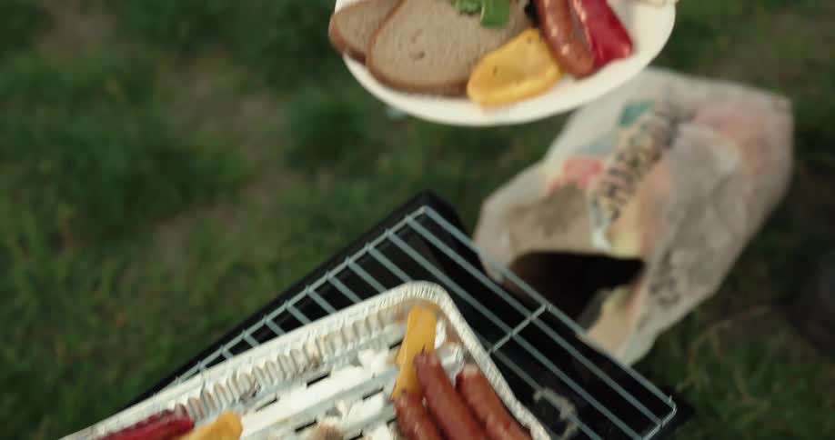 Grilled bratwurst and peppers being served outdoors