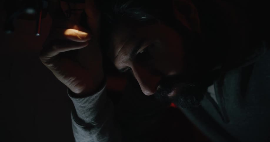 A man is adjusting a camera