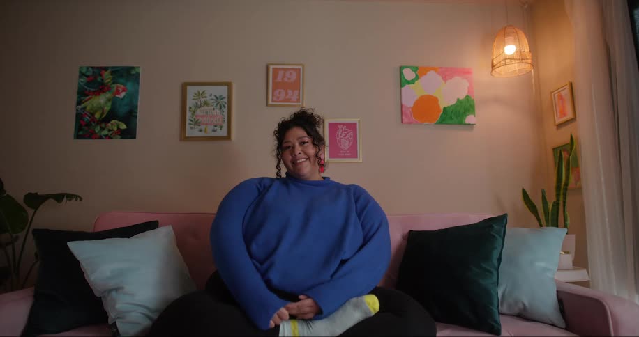 A woman smiles while sitting in bed