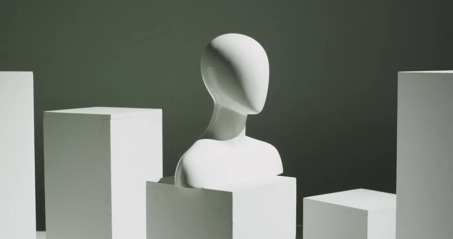 Light brightens across mannequin bust and blocks then the area darkens