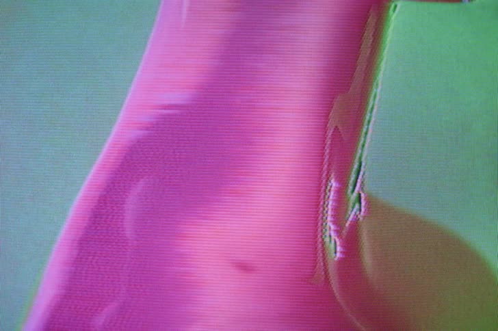 Colorful lights change as they reflect off a female figure