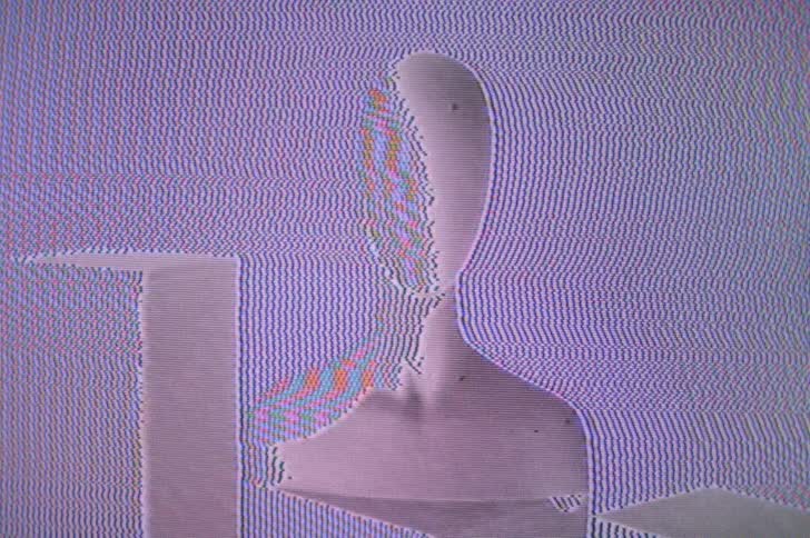 Screen showing image of faceless mannequin bust and blocks fuzzes in and out with signal static