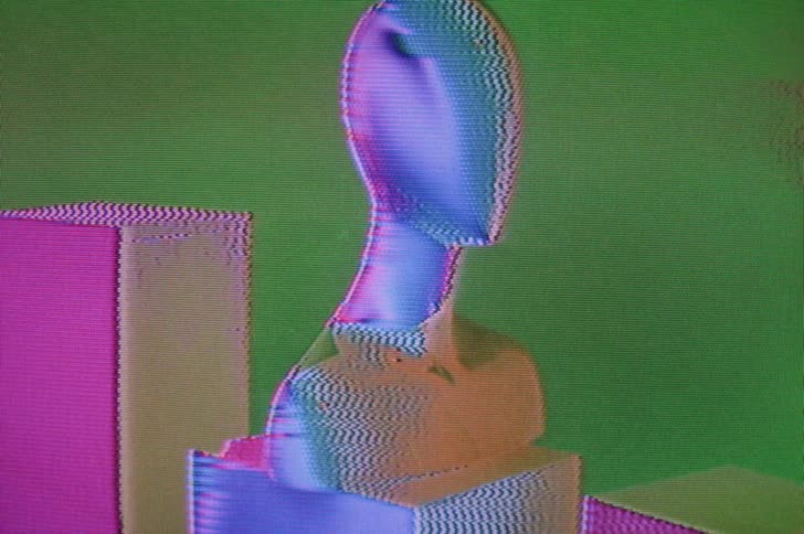 A mannequin bust form on a pedestal with changing colorful lights