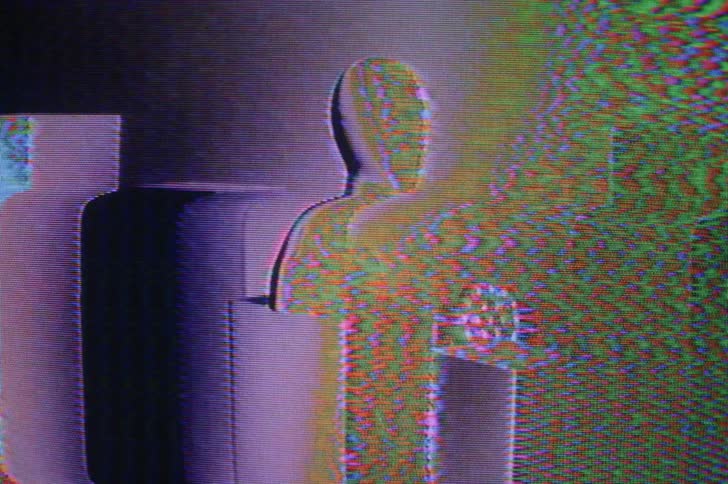 A bust sits on a block in a room with lights flashing