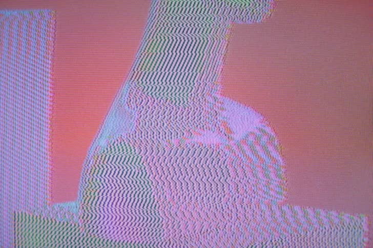 Digital image with smooth shape sitting on a block fuzzes out with signal static