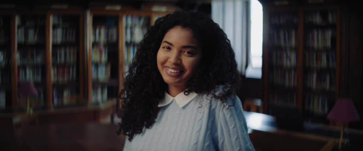 A woman smiles in the library
