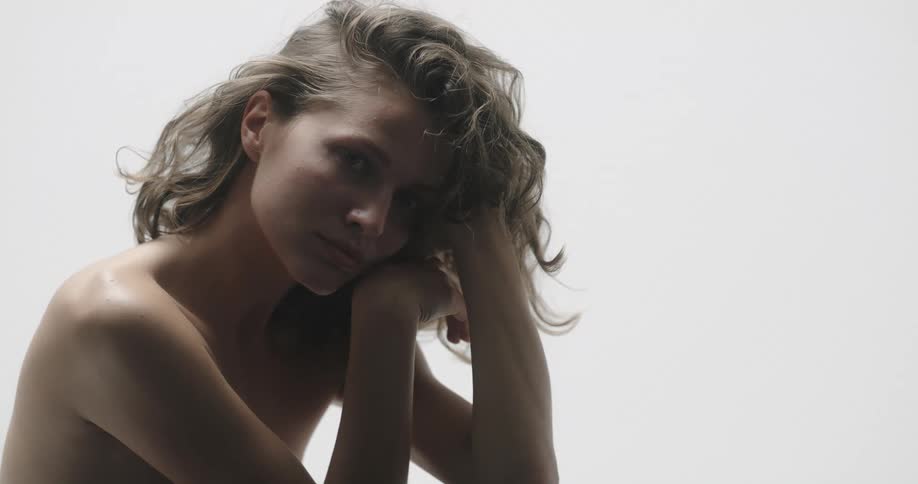 A naked woman poses for a portrait