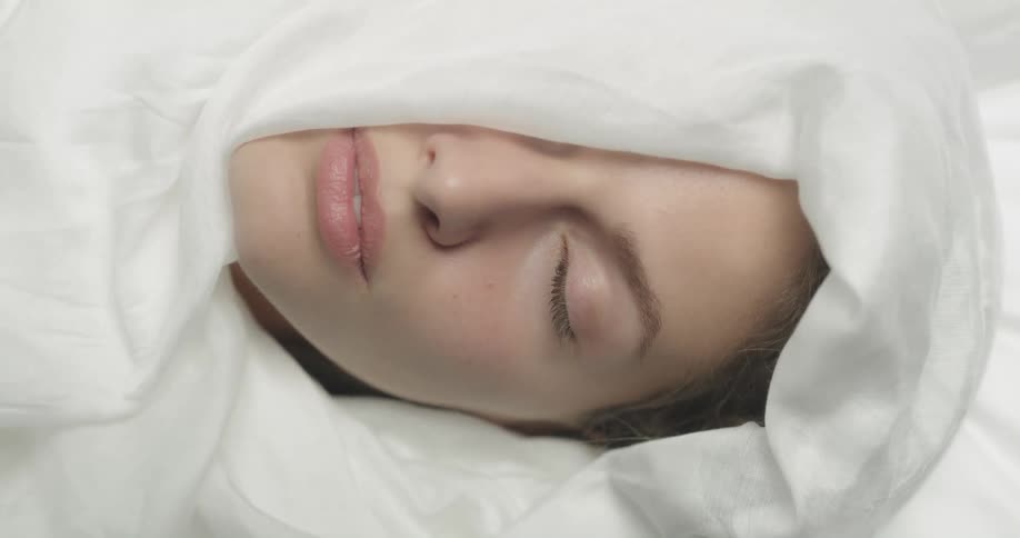 A woman is resting in bed