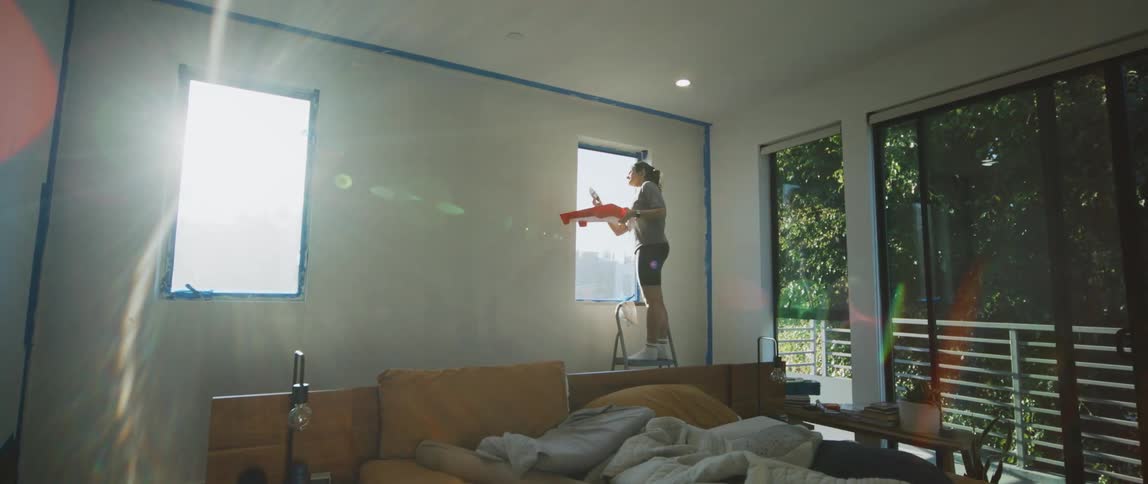A woman painting a room