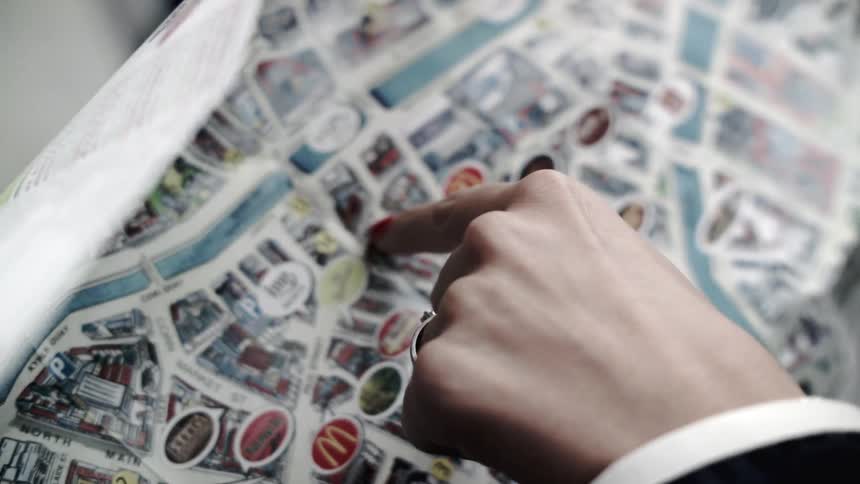 Woman pointing to point of interest on colorful map