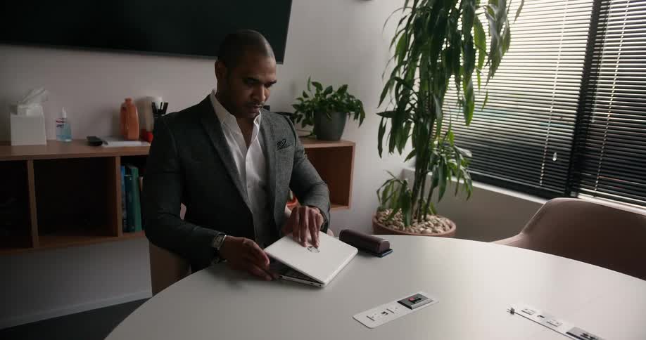 A man opens his laptop
