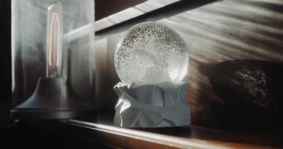 Close up view of a snow globe on a shelf is displayed