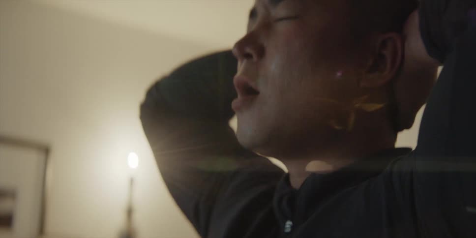 A man is standing indoors and looks upset and angry