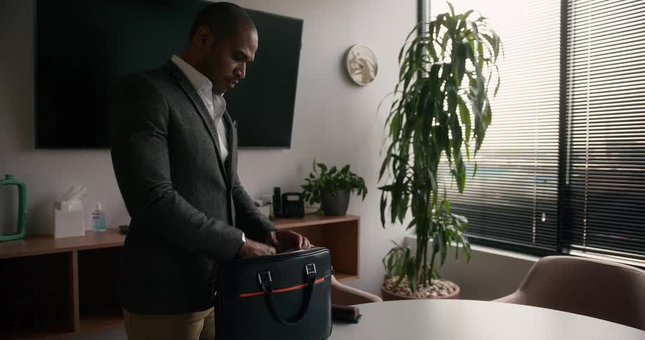 A man unloading a bag indoors