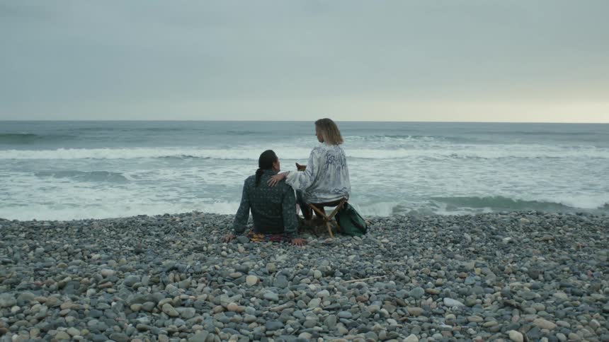 A man and woman sitting outdoors