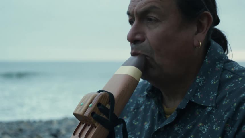 A man playing an instrument outdoors