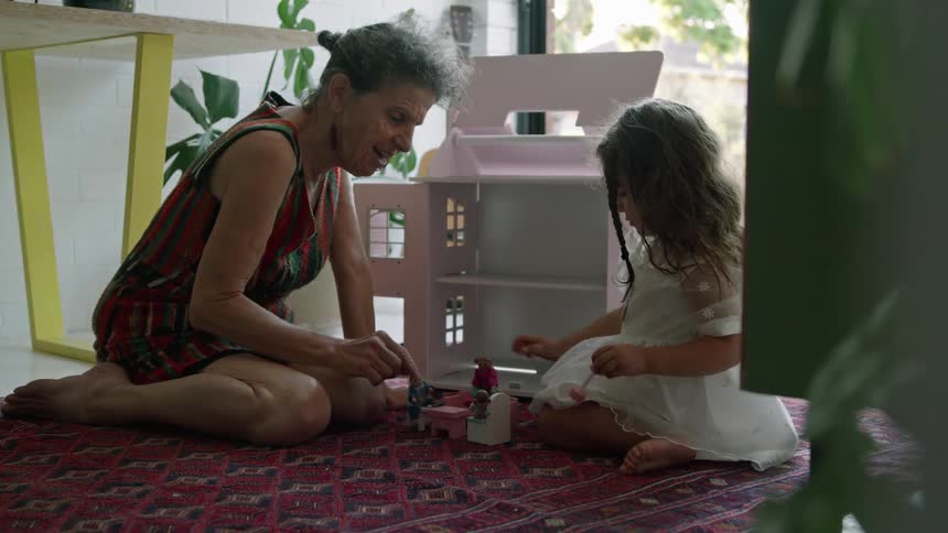 A grandmother plays with her granddaughter