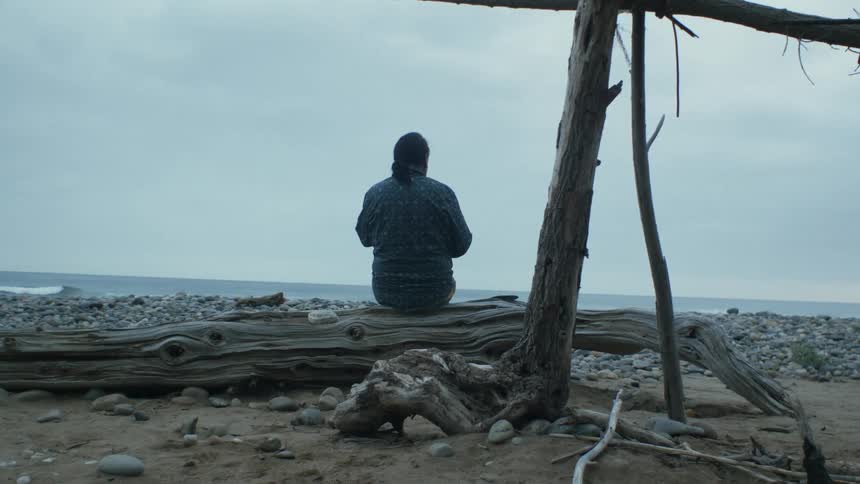 A man sitting down outdoors