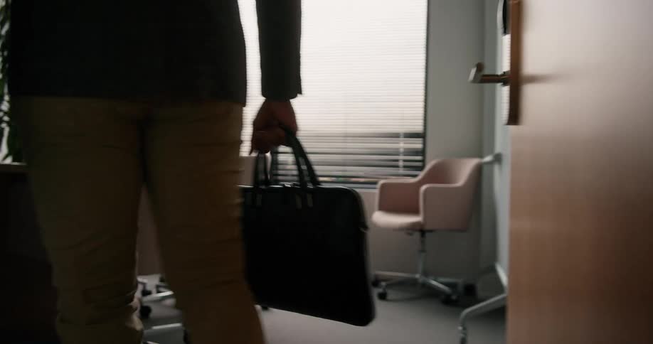 A man enters his office