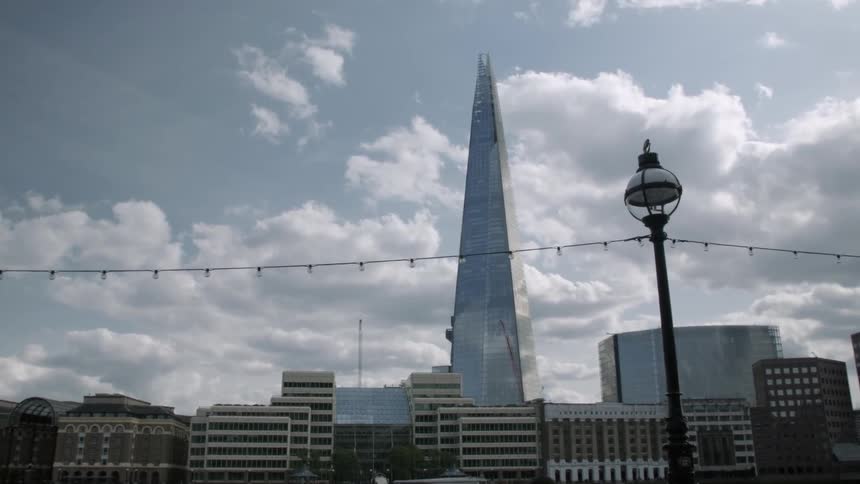 Clouds float over city buildings