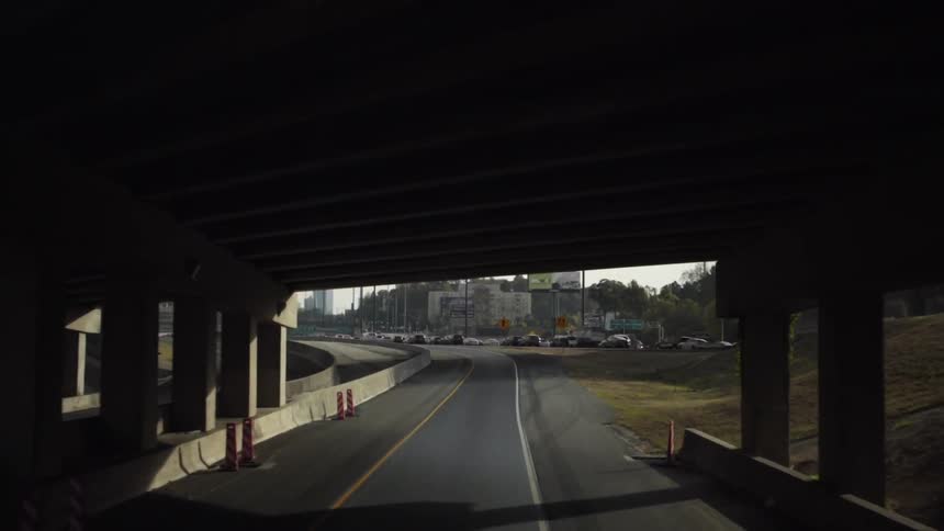 Cars drive on a city street